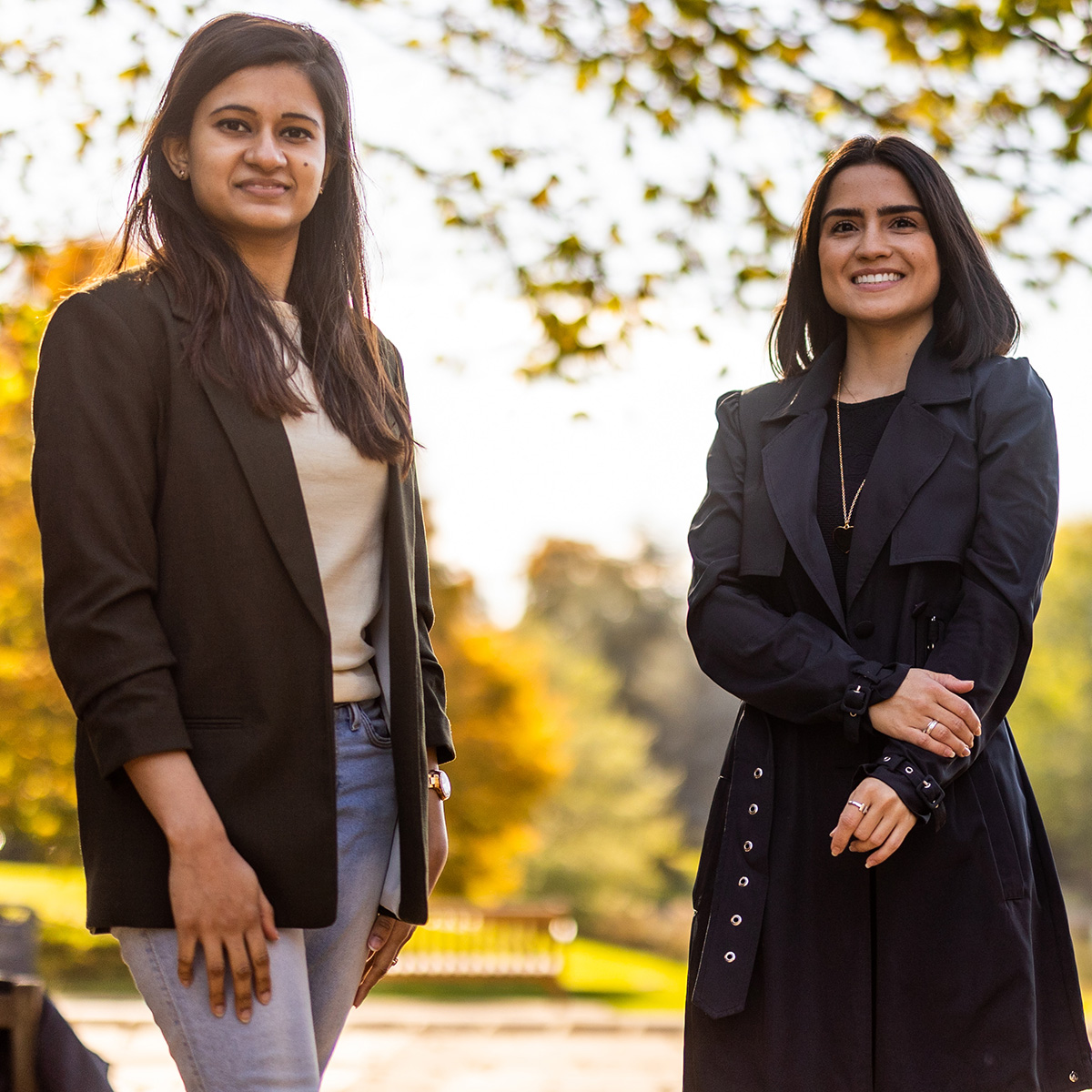 Two students smiling in the sunshine