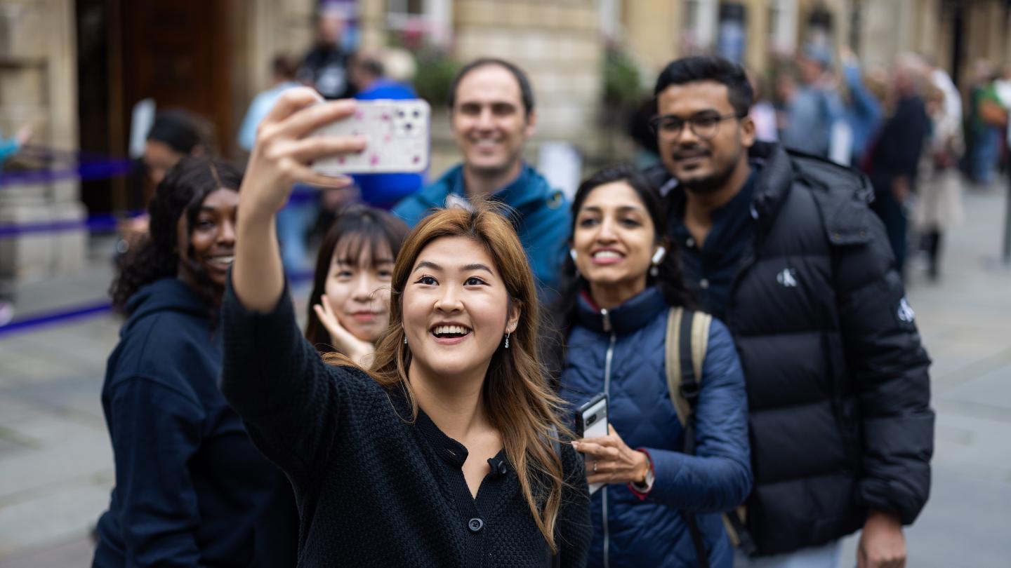 Naetima Prathipthinthong taking a selfie with a group of students in Bath