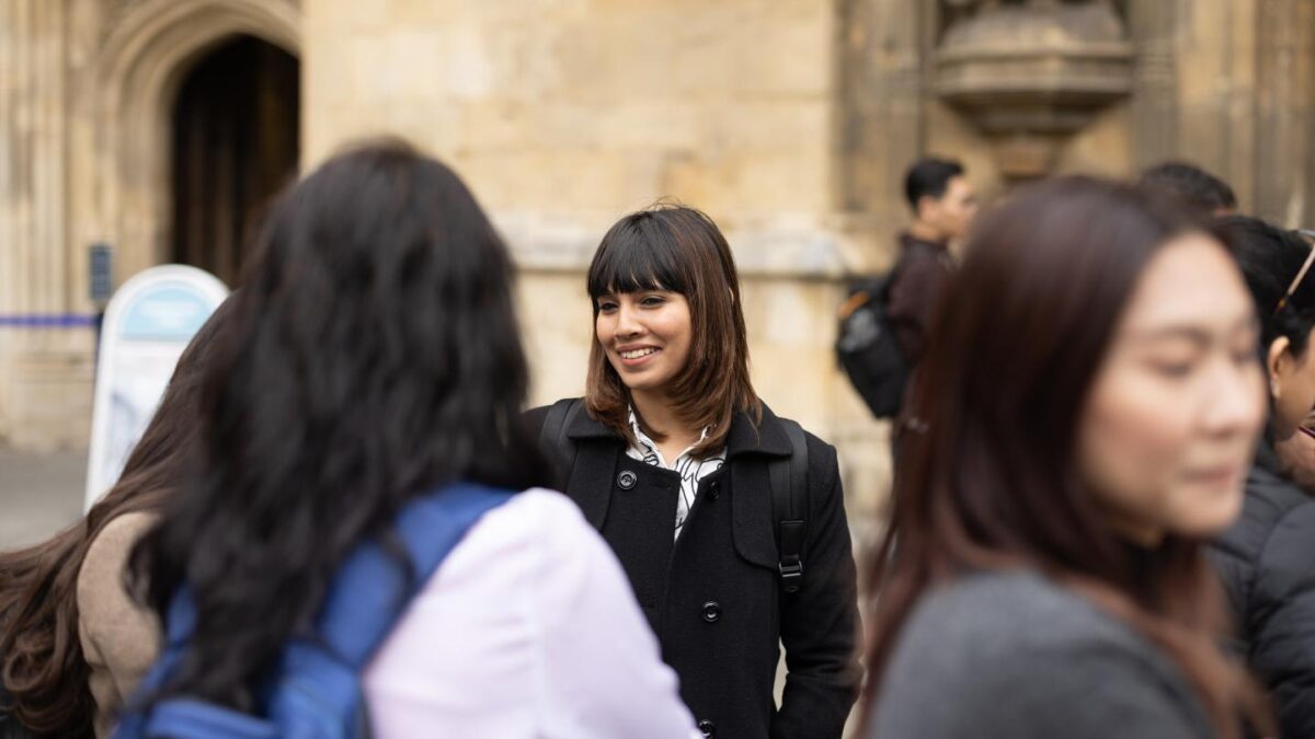 Crystal-chatting-with-a-group-outdoors-by-Bath-Abbey